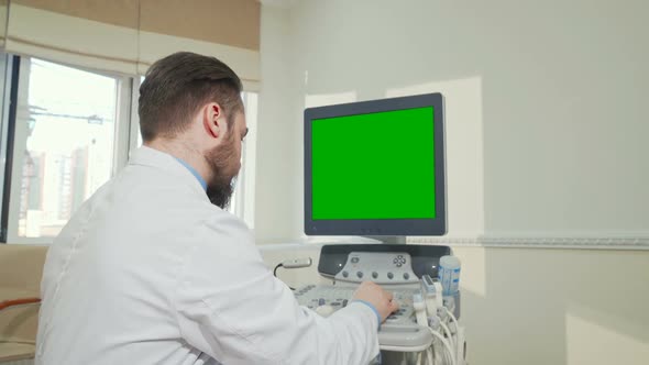 Doctor Operating Ultrasound Scanner with Green Screen