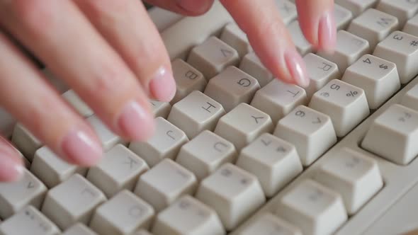 Slow motion woman hand typing on retro style keyboard keys 1080p HD footage - Pedicured female hand 