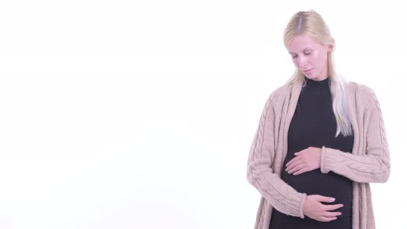 Happy Young Blonde Pregnant Woman Showing Something