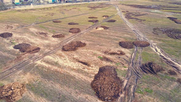Many Round Heaps of Manure on an Agricultural Field Aerial View