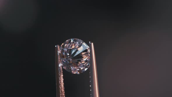 A gemologist inspecting a large clear diamond