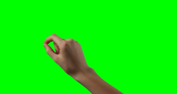 Person making hand gesture against green screen background