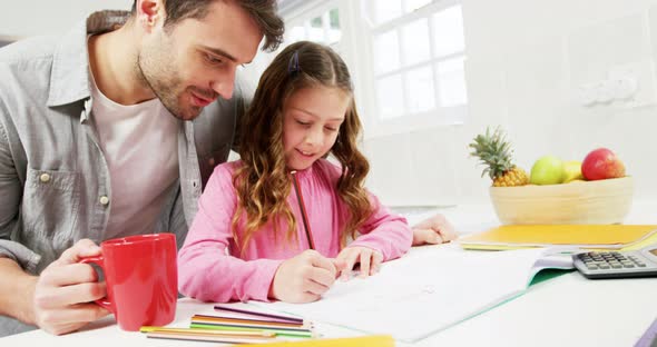 Father helping daughter with homework