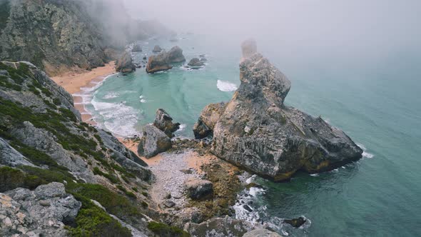  View of Rocks in Morning Fog at Praia Da Ursa Beach in Sintra, Portugal