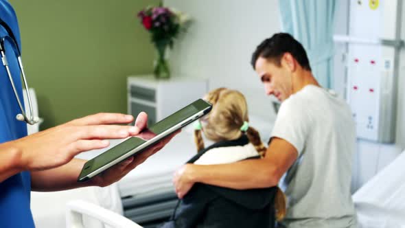 Doctor using digital tablet in hospital