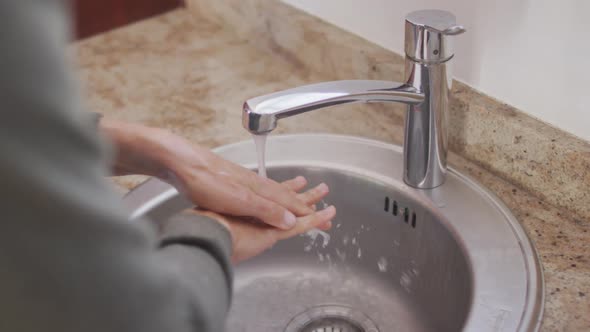 Woman in self isolation in quarantine during coronavirus pandemic washing he r hands