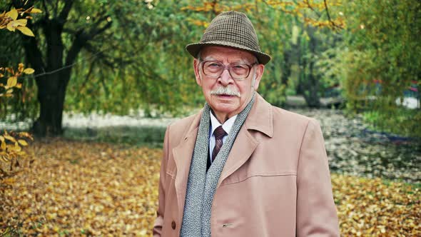 Elderly Man in Autumn Park