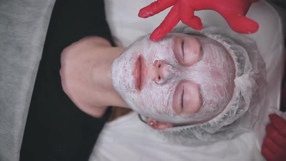 Application of a Cream Mask on the Face of a Girl with Problem Skin in the Salon