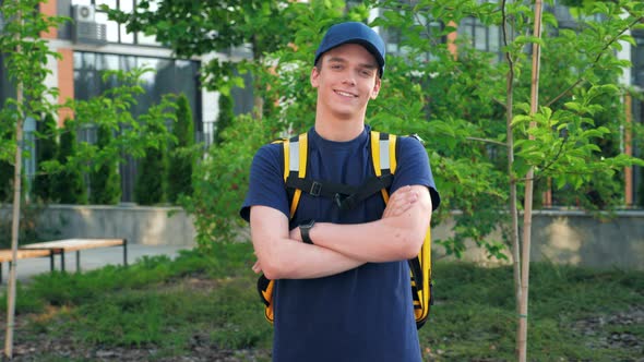 Camera Zoom in Smiling Young Man Courier Food Delivery with Thermal Backpack