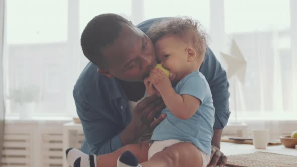 Daddy and Child Eating Apple Together