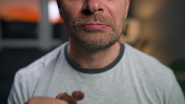 Man Eats a Chocolate Chip Cookies