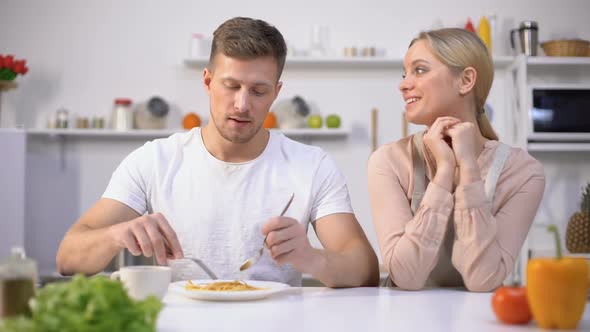 Man Pretending to Eat With Pleasure Wifes Unappetizing Meal, Couple Relationship