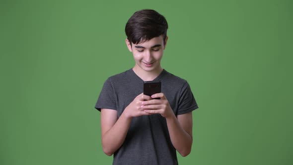 Young Handsome Iranian Teenage Boy Against Green Background