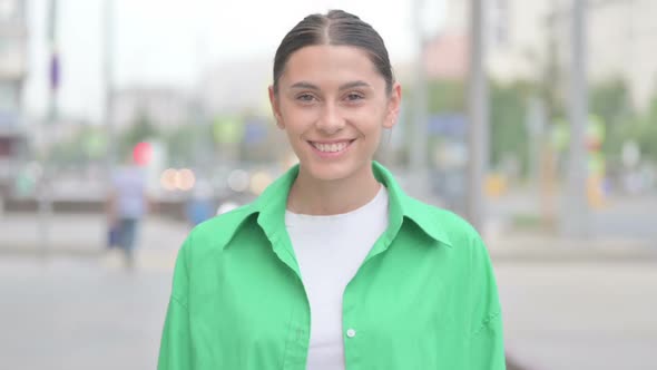 Portrait of Hispanic Woman Smiling at Camera Outdoor