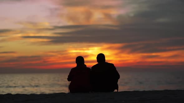 Couple Enjoy Sundown Reflection on Water