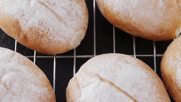 Dough balls with icing sugar on baking tray 4k