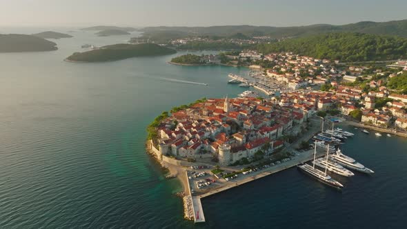 Flying Over Medieval Mediterranean Croatian Town of Korcula in Morning Sun Lights