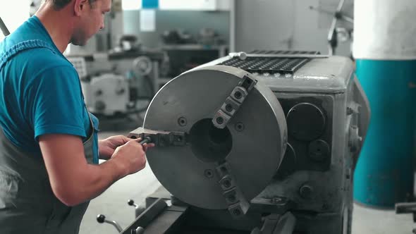 The Turner Performs Maintenance and Repair of the Lathe in the Workshop