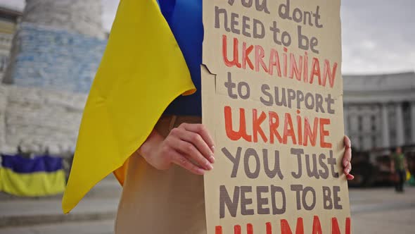 Woman Holds Poster Calling World to Support Ukraine in Fight