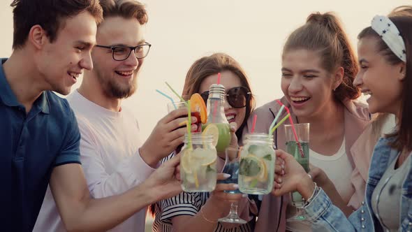 Cheerful Cocktail Party on the Roof of a Tall House