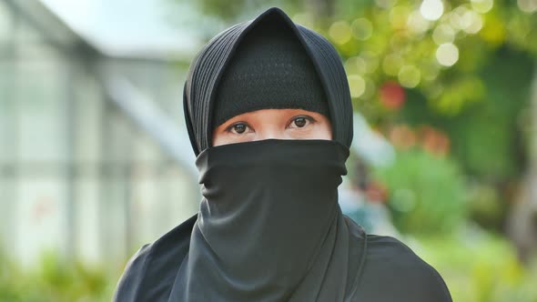 Portrait of a Young Muslim Girl in a Black Hijab