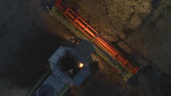 Combine Harvester Working At Night During Harvest Time