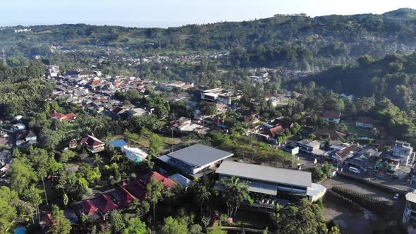 Cinematic aerial view of suburban area with a beautiful mountain in the back and clear blue sky in t