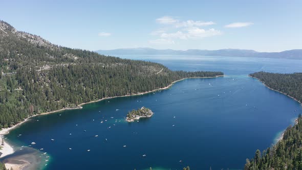 Wide panning aerial shot of Emerald Bay with boat traffic in Lake Tahoe. 4K