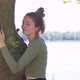 Contented Young Woman Hugging a Large Tree with a Blissful Expression and Her Eyes Closed in a - VideoHive Item for Sale