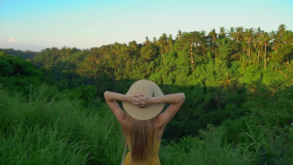 Super Slowmotion Shot of a Young Woman in a Yellow Dress Walking During Sunset at the Campuhan Ridge