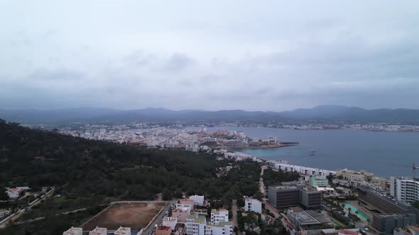 Aerial 4k view of foothills and forest in coastal town of Sant Antoni de Portmany, Ibiza