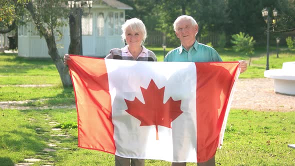 Senior Couple Holding Canadian Flag.