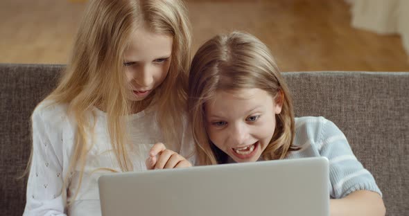 Smiling Young Two Small Kids Enjoying Using Laptop Together Watching Funny Cartoons Videos Laughing