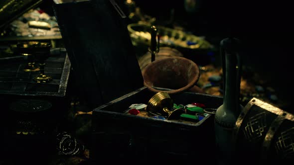 Treasures in a Dark Cave with Coins Diamonds and Gold alt