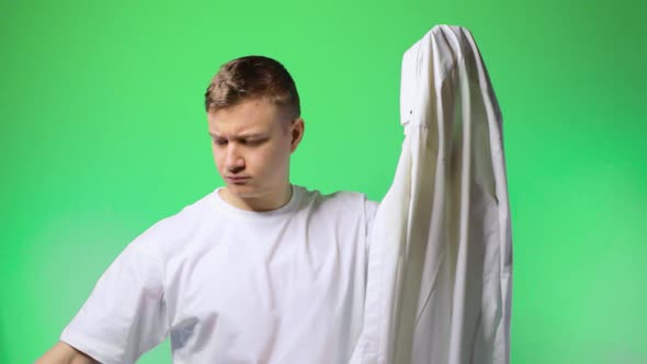 Young Man Irons a Shirt Serious Independent Chroma Key