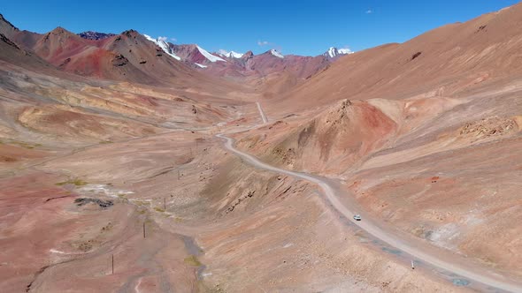 Drone View of Curved Road Crossing Hot Desert