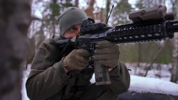 Closeup Gun with Young Man Shooting in Slow Motion Outdoors