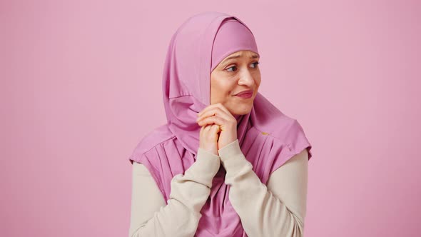 Studio Portrait of Nervous Mature Muslim Woman in Hijab Feeling Stressed and Worried Bending Her