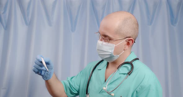 The Doctor Looks at the Temperature on Electronic Thermometer