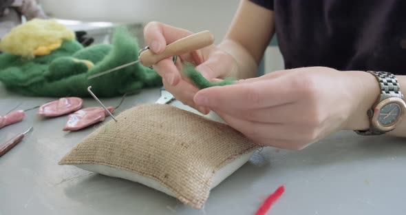 Woman Making Wool Art Doll Toy at Table Close Up. Female Sitting and Creating Ooak Doll at Home