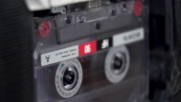 vintage audio cassette begins to play in the tape deck