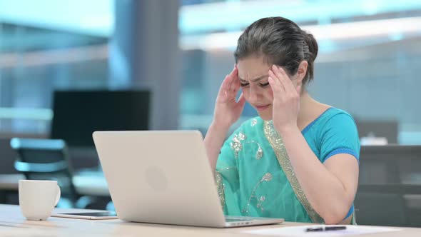 Indian Woman having Headache while using Laptop