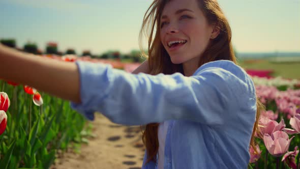 Young Woman Making Selfie in Beautiful Flower Garden