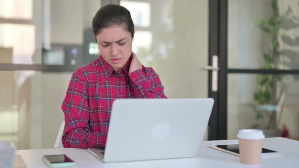 Indian Woman Having Neck Pain While Typing on Laptop