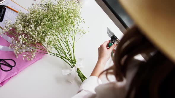 Close Up of Woman Arranging Flowers at Home