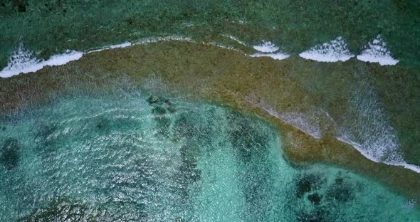 Tropical flying abstract view of a sunshine white sandy paradise beach and aqua blue water backgroun