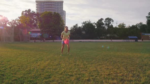 Young and Beautiful Woman Playing Frisbee in the Park Slow Motion