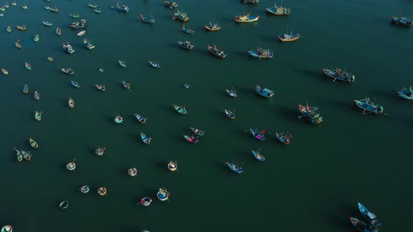 Aerial view of dozens of fishing boats moored in the sea in Vietnam