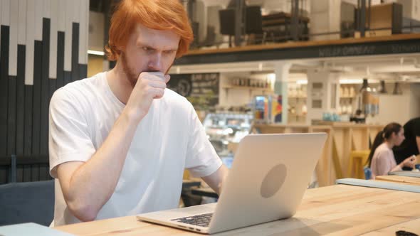 Working Redhead Beard Man Coughing, Sitting in Cafe