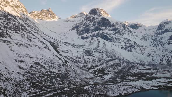 Incredible aerial shot of snow covered mountains on Kvaloya, Norway